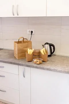 Kitchen snack takeaway delivery setup with paper bag, wafers, and nuts desser Stock Photos