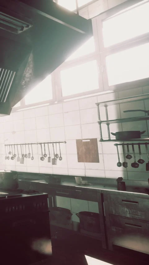 Kitchen space in a restaurant with hanging utensils and bright windows Stock Footage 338379671