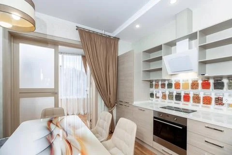 A kitchen with a spice rack on the wall and a spice rack on the counter Stock Photos