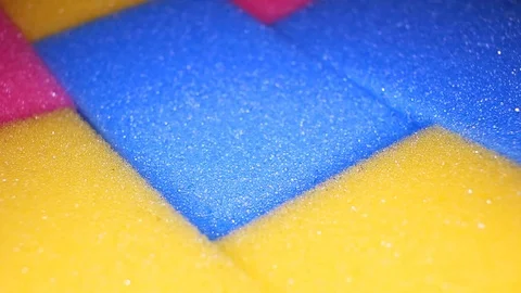 Kitchen sponge sponges closeup texture video on rolling rotating looping plate Stock Footage 104330856
