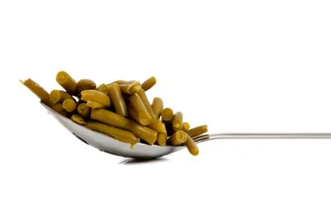 A kitchen spoon full of green beans Stock Photos