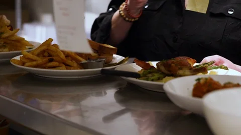 Kitchen staff getting food orders Stock Footage 127930033
