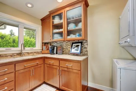Kitchen storage combination with multicolored backsplash in the corner of kit Stock Photos