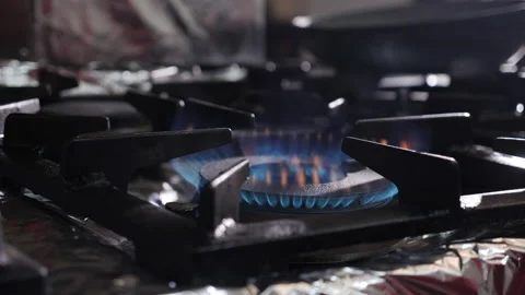 Kitchen stove burner turning on  - camera push in, close up Stock Footage 151405512