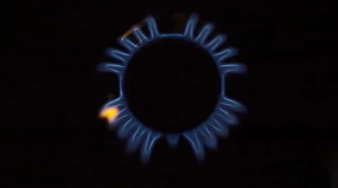 In the kitchen stove ignited the fire in the burner on a black background 스톡 동영상 64686086