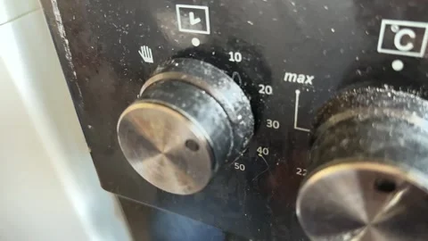 Kitchen stove knobs close up at home with hand adjusting control, changing heat Stock-Footage 337104503