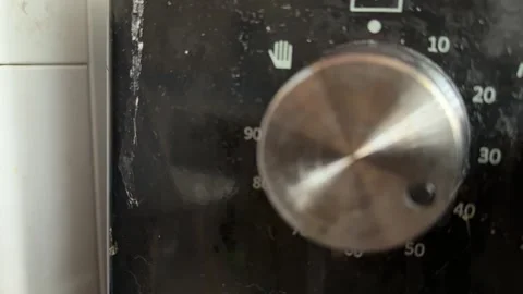 Kitchen stove knobs close up at home with hand adjusting control, changing heat 库存影片 337104758