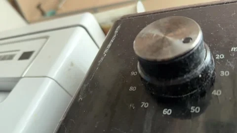 Kitchen stove knobs close up at home with hand adjusting control, changing heat 库存影片 337104763