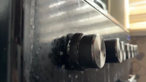 Kitchen stove knobs close up at home with hand adjusting control, changing heat 库存影片 337104768
