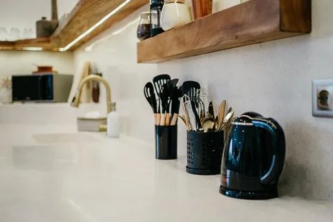 Kitchen stuff and kettle. Bright white modern design of luxury kitchen with w Stock Photos