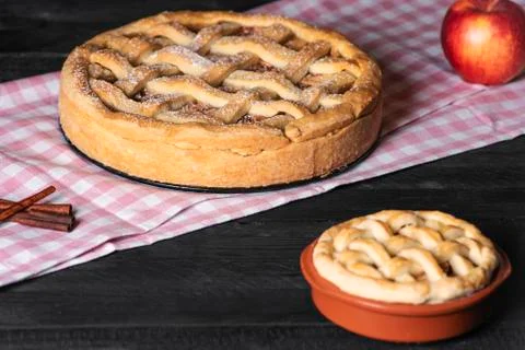 Kitchen table with apple pies. Traditional baked dessert. Sweet pastry. Stock Photos