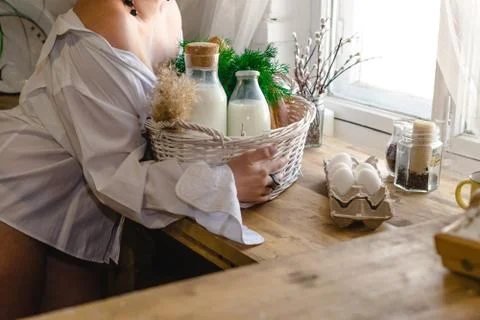 Kitchen table with bottled milk and herbs Stock Photos