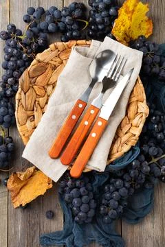 Kitchen table with empty rattan plate, blue tablecloth on old wooden backgrou Stock Photos