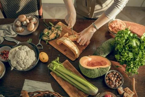 Kitchen table filled with fresh vegetables and natural ingredients, showcasing Stock Photos