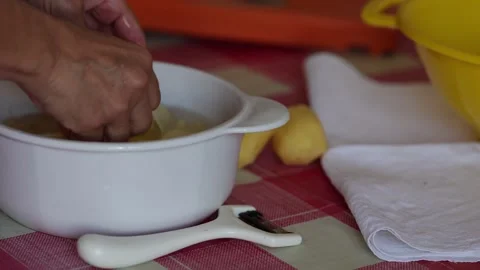 Kitchen Table Prep with Peeled Potatoes and Water Bowl Stock Footage 346032801