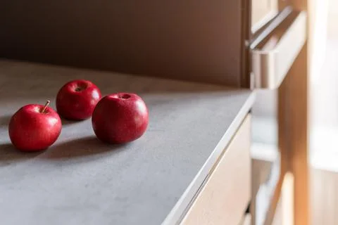 Kitchen table with red apples. Modern kitchen interior, close up Stock Photos