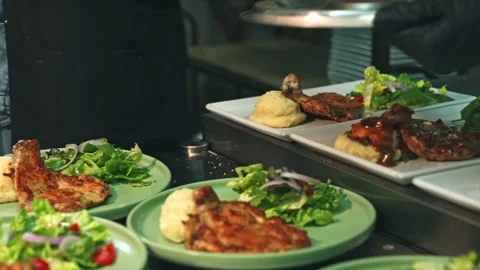 Kitchen Team Preparing and Serving Multiple Chicken Chop Plates Stock-Footage 342219651