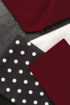 Kitchen textile on black rustic wooden background, napkin and towel set, fold Foto stock