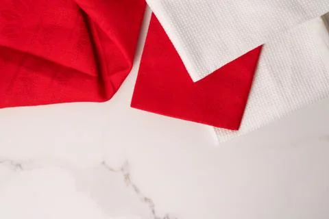 Kitchen textile on chic white marble background, napkin and towel set, folded Stock Photos