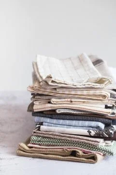 Kitchen textile. stack of fabrics in different colors and textures, close-up. Stock Photos