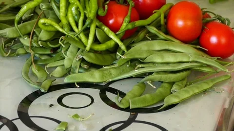 In the kitchen there is green beans, tomatoes and fine pepper, 스톡 동영상 101354077