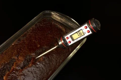 Kitchen thermometer on a cake 스톡 사진