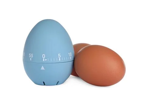 Kitchen timer and chicken eggs on white background Foto stock