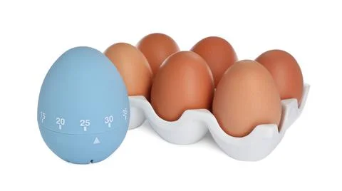 Kitchen timer and chicken eggs on white background Foto stock