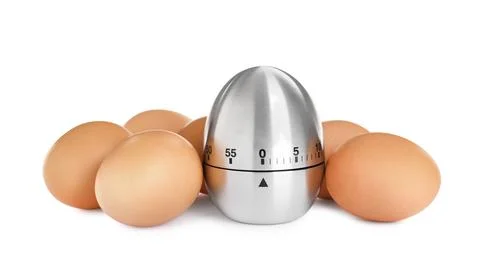 Kitchen timer and chicken eggs on white background Foto stock