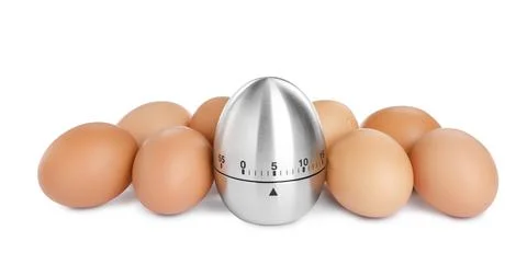 Kitchen timer and chicken eggs on white background Foto stock