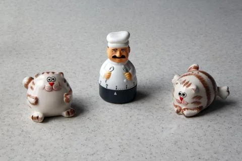 Kitchen timer in the form of a chef figurine and two cats Stock Photos