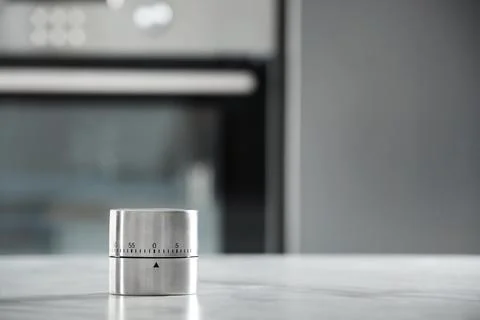 Kitchen timer on light grey table indoors. Space for text Foto stock