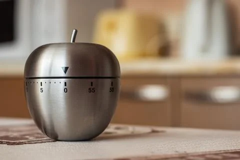 Kitchen timer in shape of apple on table. Space for text Stock Photos
