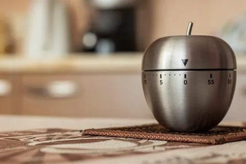 Kitchen timer in shape of apple on table. Space for text Stock Photos