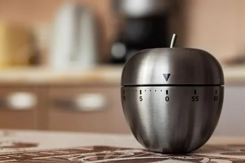 Kitchen timer in shape of apple on table. Space for text Stock Photos