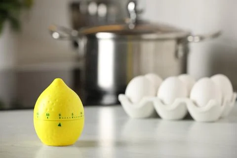 Kitchen timer in shape of lemon on white table indoors. Space for text Stock Photos