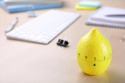 Kitchen timer in shape of lemon on wooden table, closeup. Space for text Stock Photos