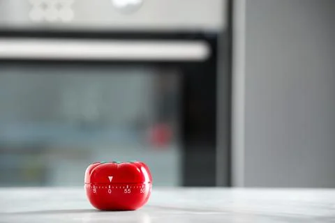 Kitchen timer in shape of tomato on light grey table indoors. Space for text Stock Photos