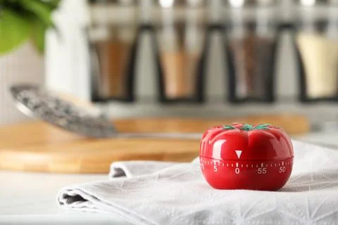 Kitchen timer in shape of tomato on white table. Space for text Stock Photos