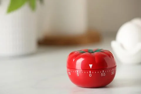 Kitchen timer in shape of tomato on white table. Space for text Stock Photos