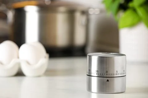 Kitchen timer on white table indoors. Space for text Stock-Fotos