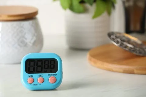 Kitchen timer on white table. Space for text Stock Photos