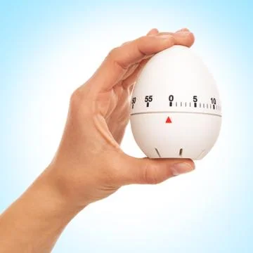 Kitchen timer in woman's hand Stock Photos