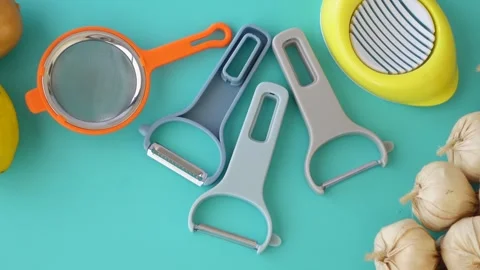 Kitchen tools collection with garlic and vegetables on turquoise background.. Stock Footage 333151943