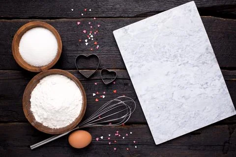 Kitchen tools, flour and sugar on a wooden background Stock Photos