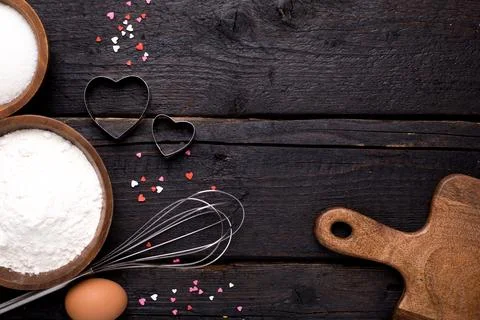 Kitchen tools, flour and sugar on a wooden background Stock Photos