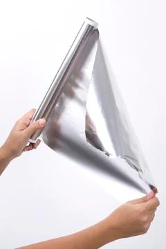 Kitchen utensils and tools, hand with aluminum foil Stock Photos
