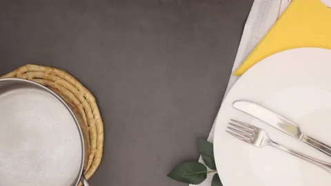 Kitchen utensils appear on table and pasta filling white dishes - Stop motion Video stock 130728910