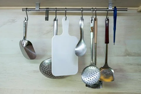 Kitchen utensils hanging in the kitchen Stock Photos