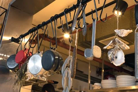 Kitchen utensils hung on hooks in the kitchen Foto stock